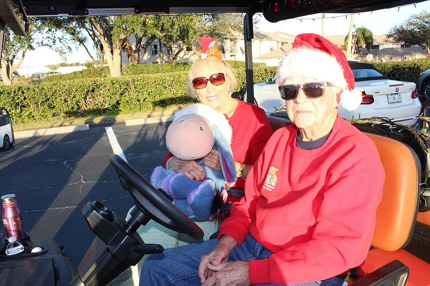 Maria Somers and Mike Mazzariella brought a little company with them for the Tara Holiday Golf Cart Parade.