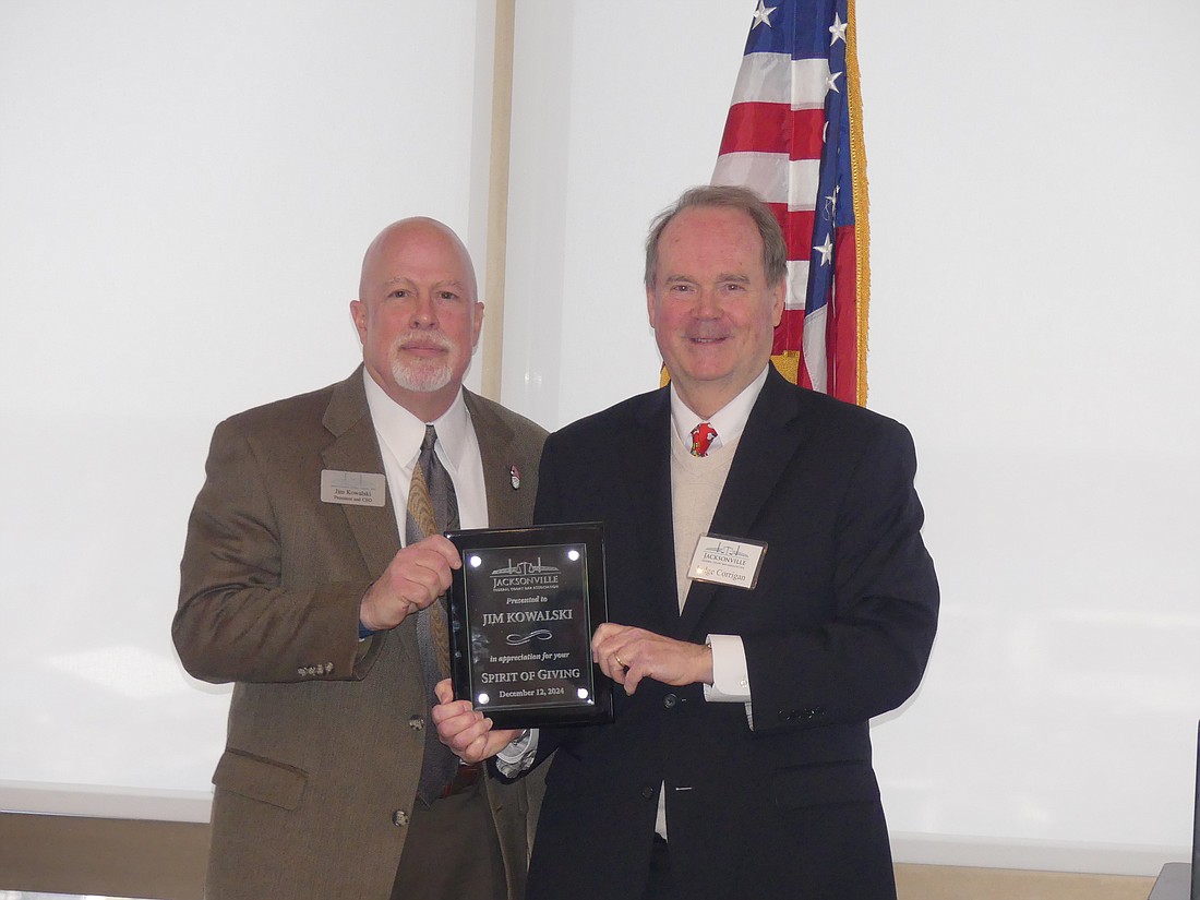 Senior U.S. District Judge Timothy Corrigan, right, presented the Spirit of Giving Award for civil practice to Jacksonville Area Legal Aid President and CEO Jim Kowalski.