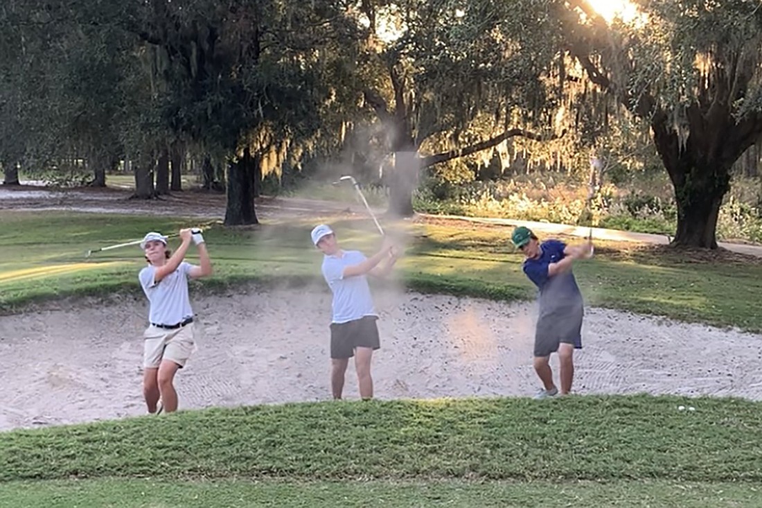 Lakewood Ranch High sophomore Brett Traver (middle) emerged as the team's third best golfer in 2024. Sophomore Owen Gellaty and senior Luke Wilson work alongside Traver on their bunker play in preparation for the 2024 state tournament.