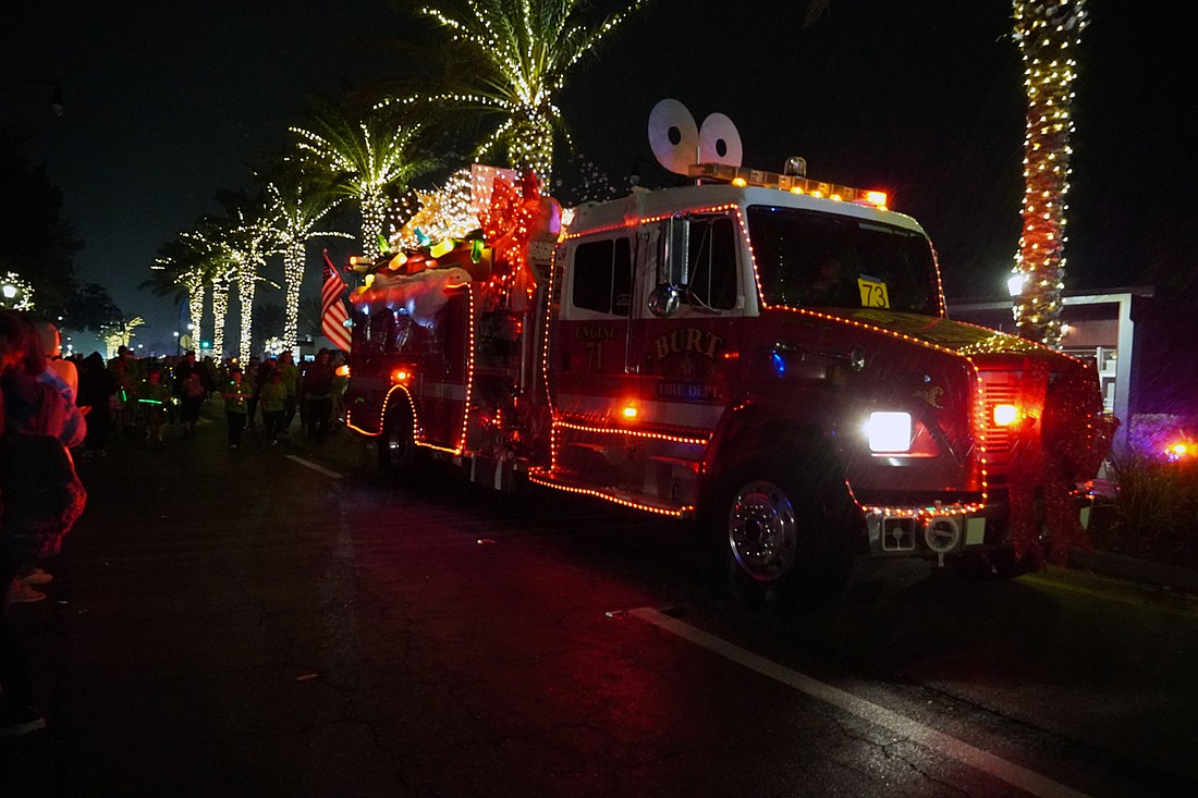 In line with the parade theme, Security First's float featured a vintage “toy” fire truck adorned with giant Christmas lights made from recycled 2-liter bottles and topped with a working, life-size wind-up key. Courtesy photo