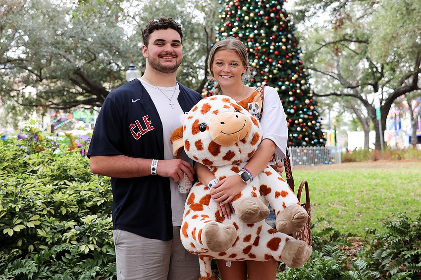 Liam Downs won his girlfriend Helaina Rogers this cow by throwing darts at balloons. How much did he spend? 