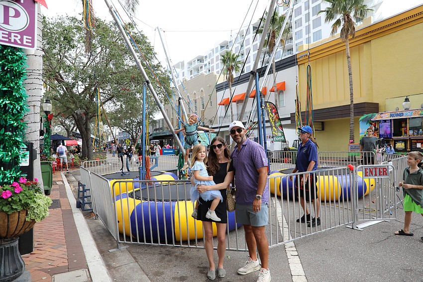 5-year-old Mackenzie Nichols bounces while her parents Mychal and Steph and baby sister Emmy, 2, cheer her on.