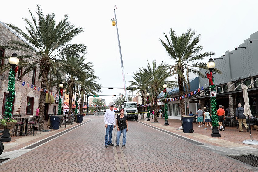 Ron Soto and Darci Jacob, president of Destination Downtown, take a quick minute to size up the pineapple, which will begin its decsent at 11:59 p.m. on New Year's Eve.