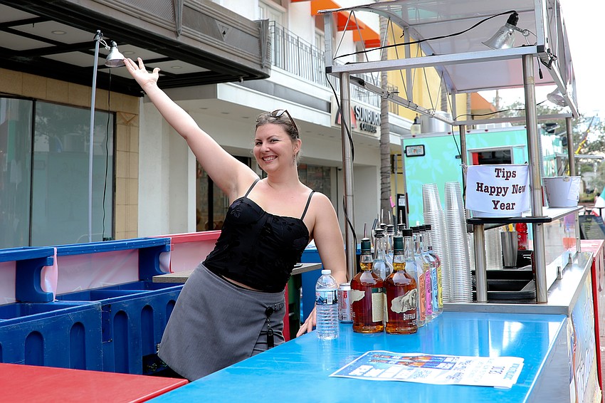 Gator Club's Tessa Merkel serves libations during the Destination Downtown Pineapple Drop.