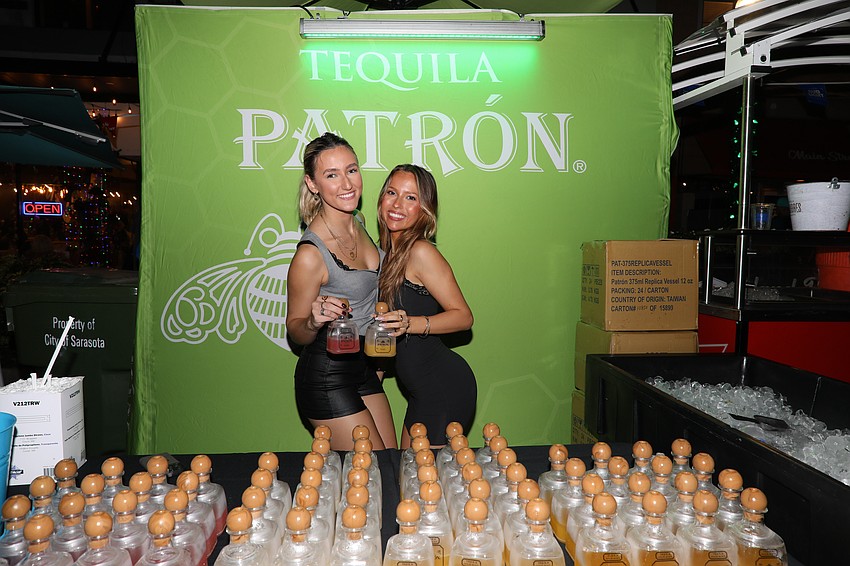 Emily Schneider and Eden Sanders sell keepsake bottles of a Patron Margarita.