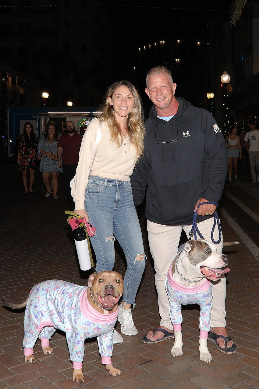 With huge smiles the well dressed and behaved pups Peter Rose and Rupert Ann stop for a photo with their humans, Jen and Clay Owens.