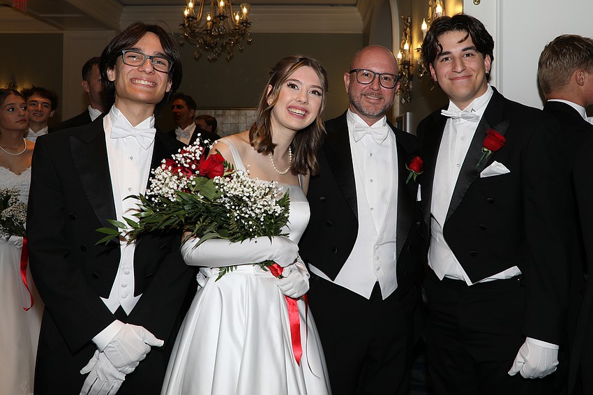 Eliza Radford with escorts Ethan Downes, dad Kevin, and Graham Downes.