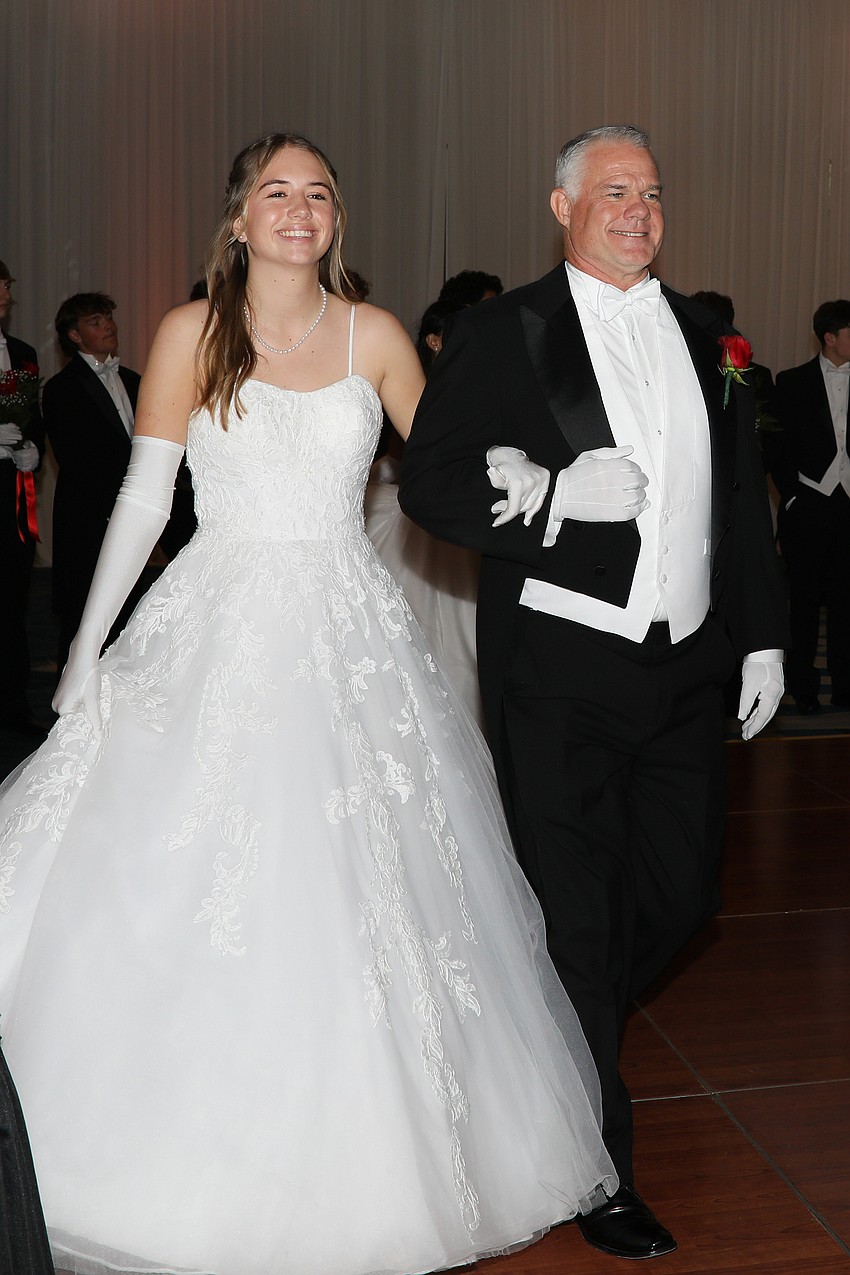 Debutante Reagan Hughes is presented by her dad, Jason.