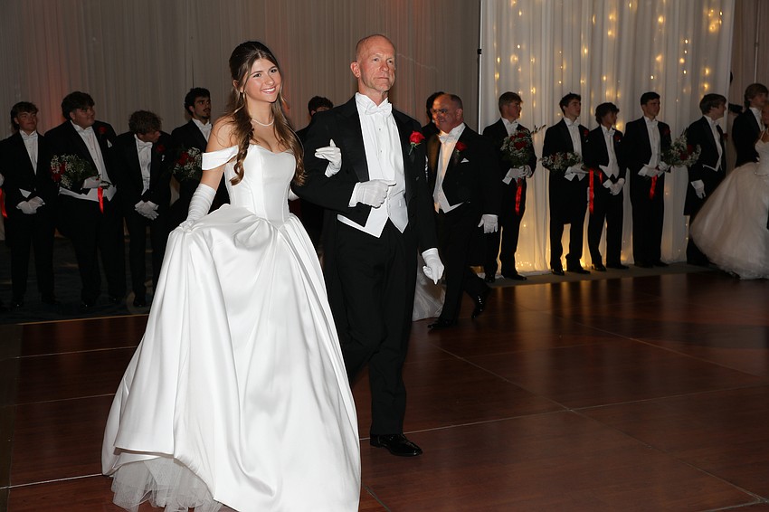 Debutante Lola Delbridge is presented by her dad, Toby.