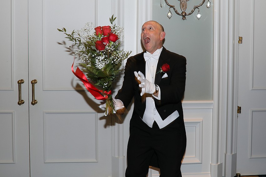 Russell Vega catches his daughter Jillian's rose bouquet as she readies for a photo.