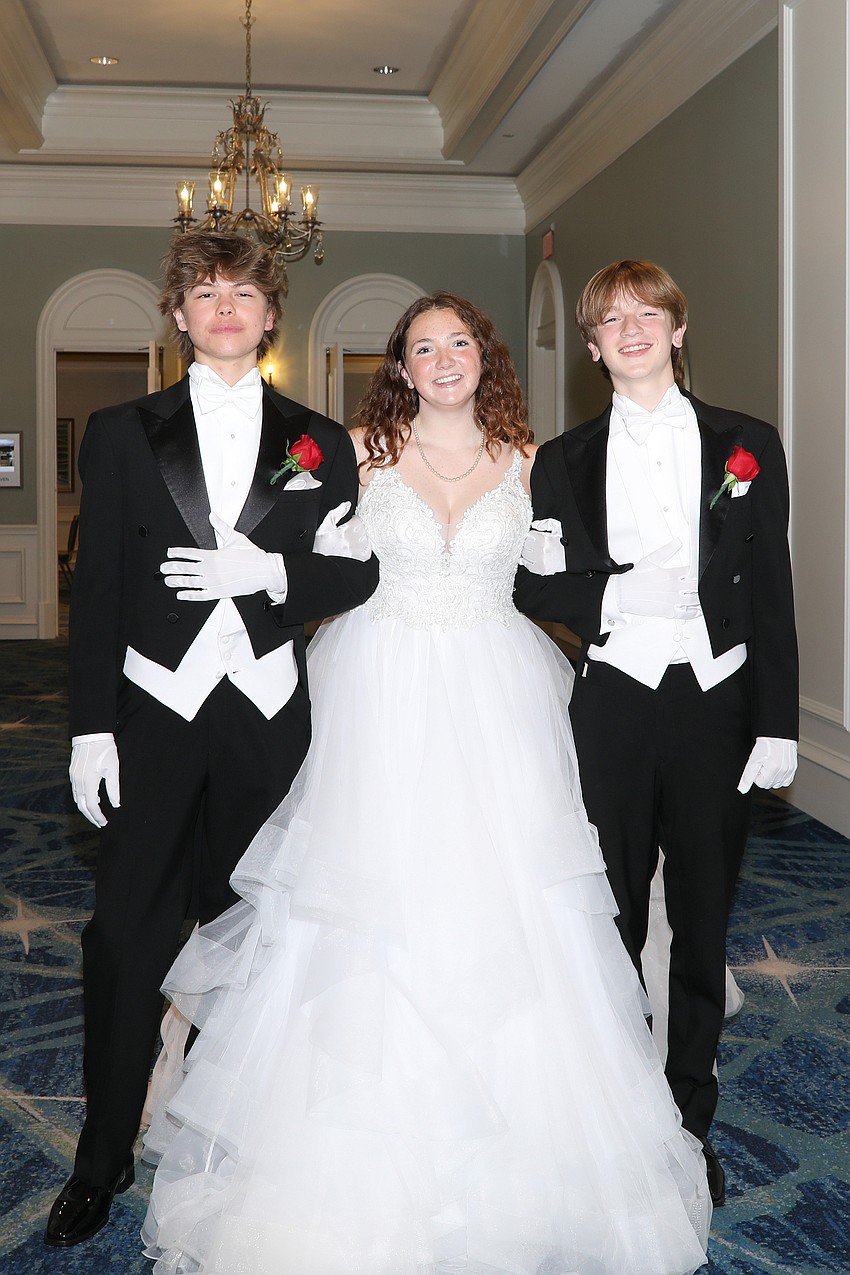 Debutante Jillian Vega is escorted by Ty Charleton and Alonzo Jaramilo.