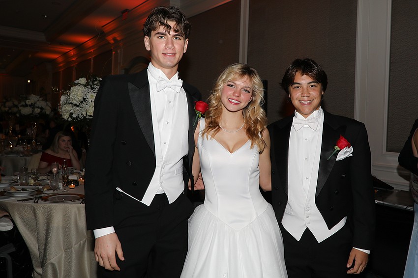 Debutante Betsy Neal with escorts Brady Buskirk and Gabriel Conn.