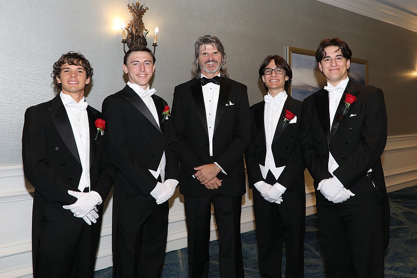 Debutante escorts Vince Oser, Parker Wilding, Ethan Downes and Graham Downes with committee member Pepper Dietz , center.