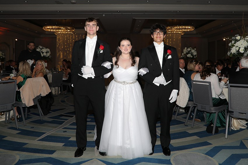 Debutante Emily Paetsch is escorted by Ira Jackson and Noah Luna.