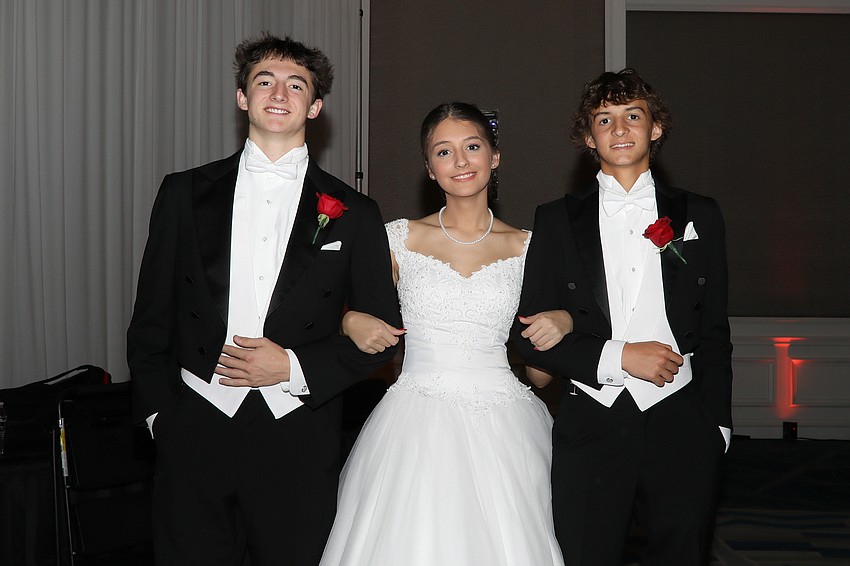 Debutante Emma Rigney with escorts Chase Johnson and Ben Rigney.