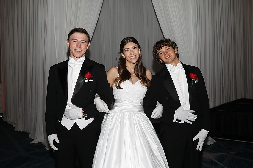 Debutante Mia Rosenthal with her escorts Parker Wilding and Vince Oser.