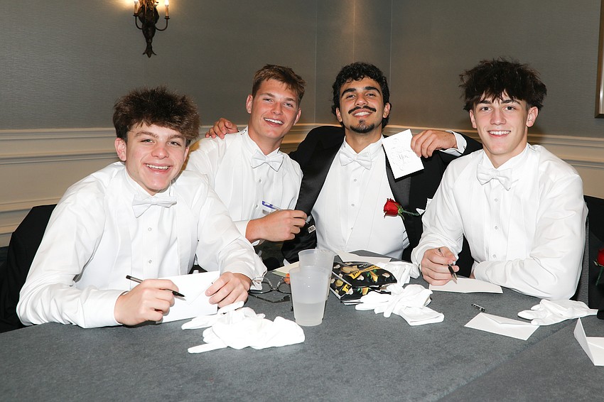 Tristyn Opstal, Graham Jaynes, Rodrigo Berrios and River Rell write thank you notes to the debutantes they will escort at the Debutante Ball.