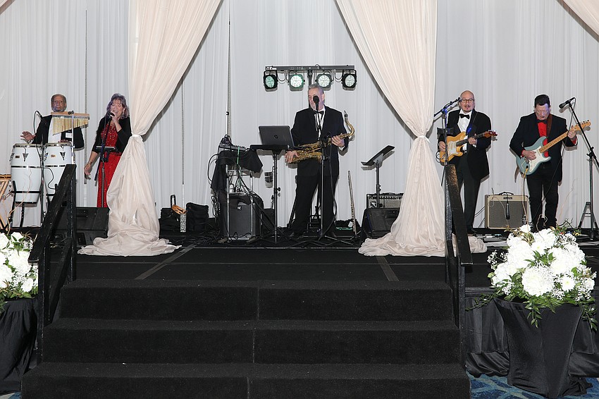 It's the 11th year for the TopSpin band to perform at the Debutante Ball. Members include Hector Gonzalez, Kathy McAbee, Gene Cannon, John Mayeux and Paul Buzine.