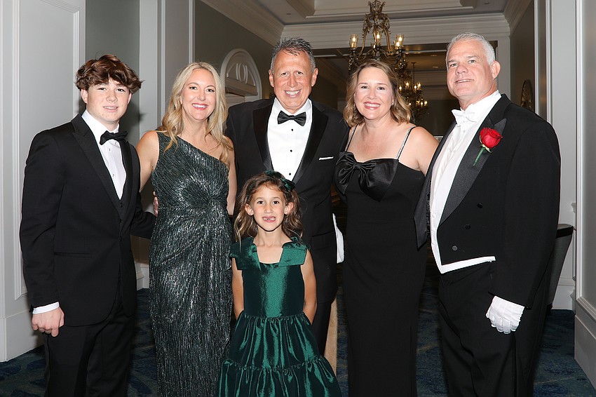 William Hughes, Brigid and Shane Saah, Leigh and Jason Hughes and Piper Saah (front) enjoy the cocktail hour.