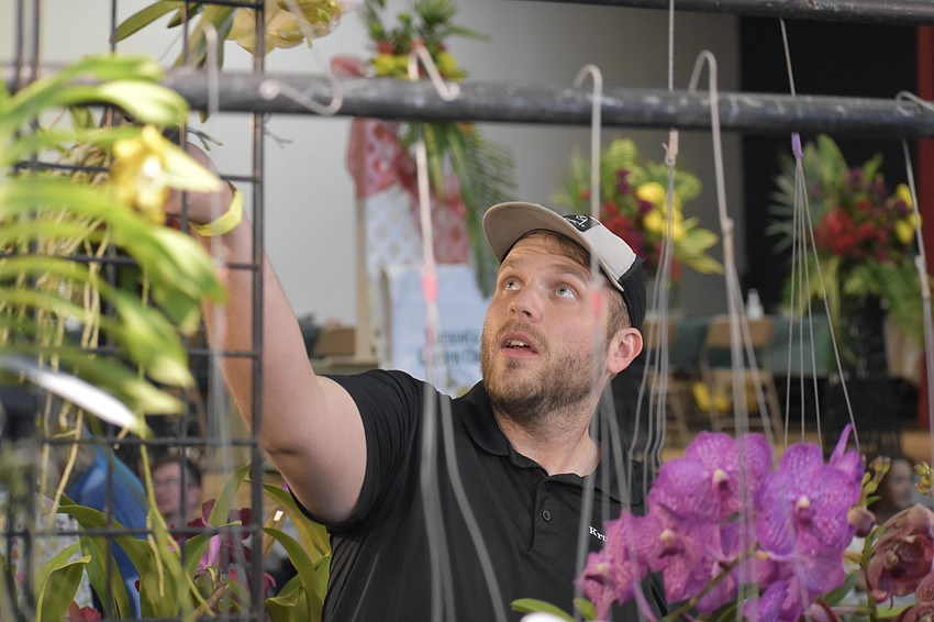 Hayden Jensen of Krull-Smith lifts an orchid.