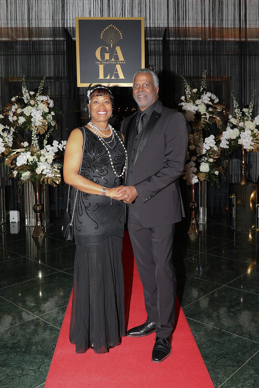 Kim and Greg Parris at the entry of the 1920s style speakeasy.