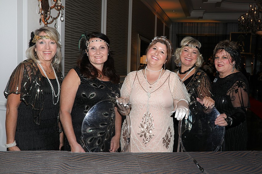 Lisa Walik, Shana Meadows, Janessa Alexandre, Kathy Klimasara and Lori Kaires volunteer at the registration desk.