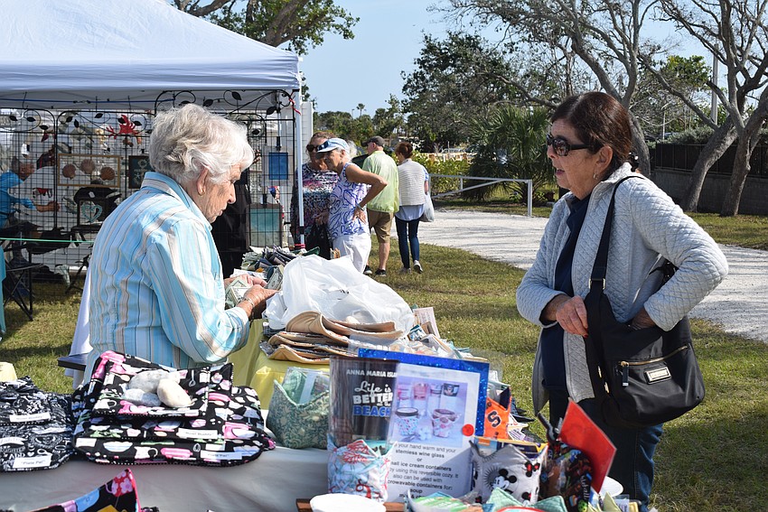 Cindy Barnett buys a set of cozies from Kay Heigle at Market on the Key.