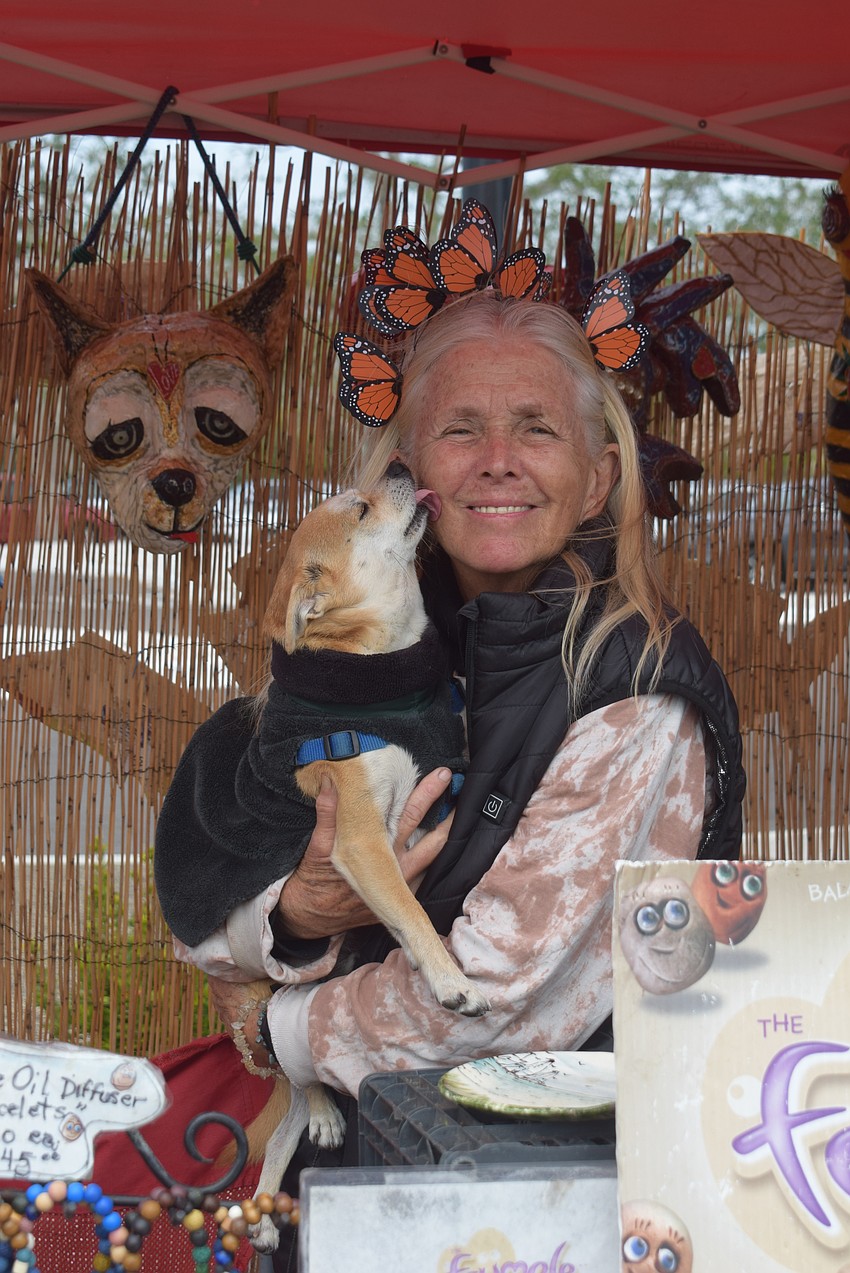 Paula Knudsen and her dog Mango at her booth at the Market on the Key.
