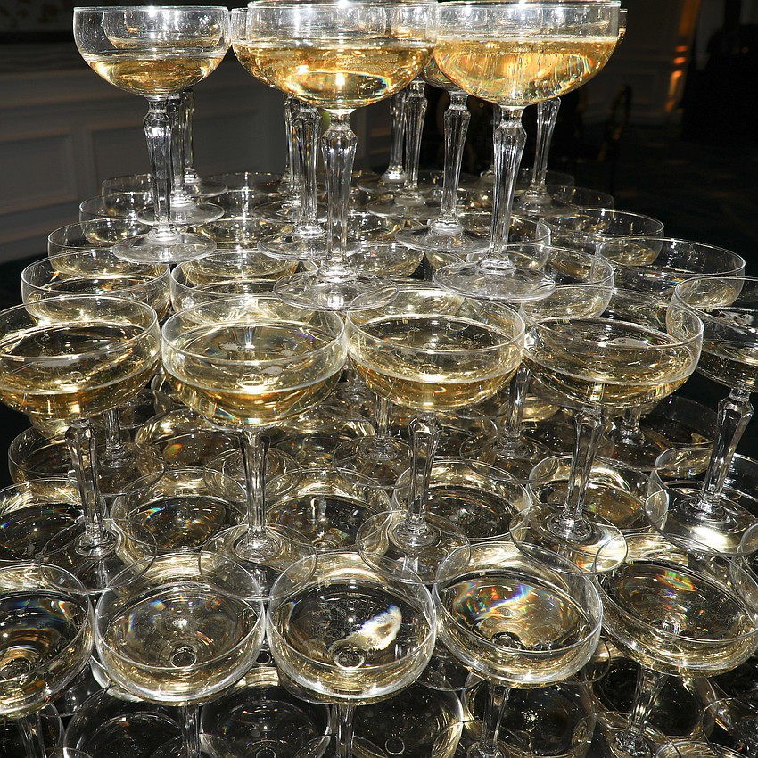 The precariously produced champagne tower is wildly popular among party guests.