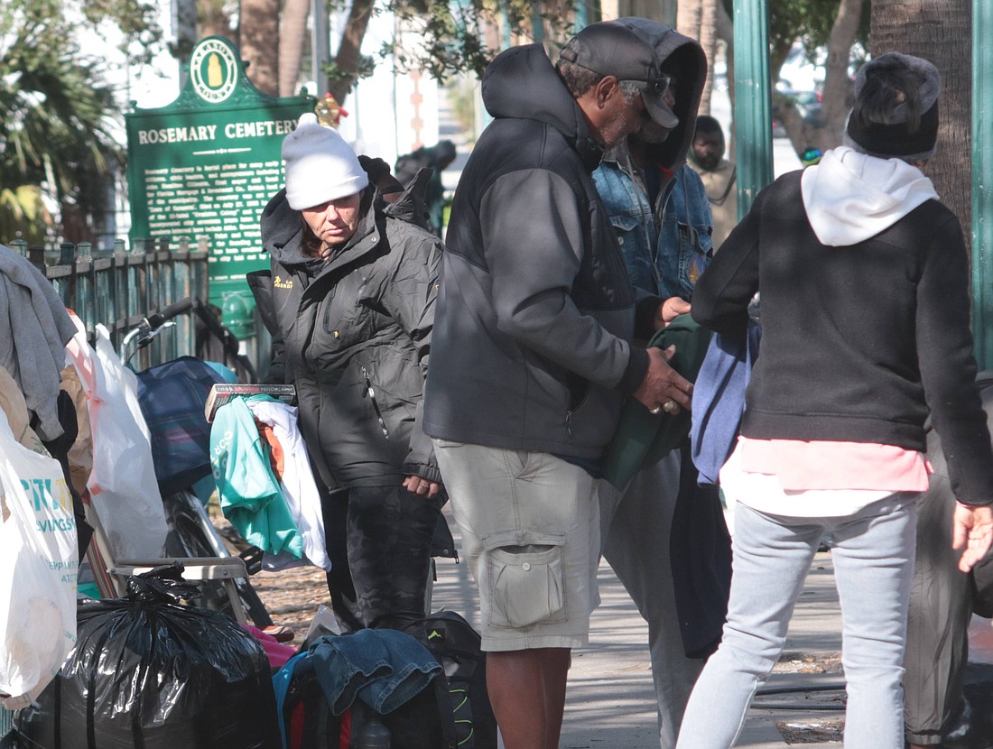 People wait outside the Salvation Army shelter on 10th Street in Sarasota. Cold temperatures have prompted the county to arrange for shelters to open Jan. 7-8.