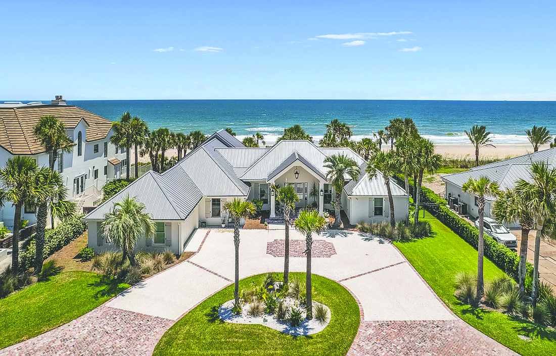 Oceanfront single-story home features four bedrooms, four full and one half-bathrooms, porch and patio.