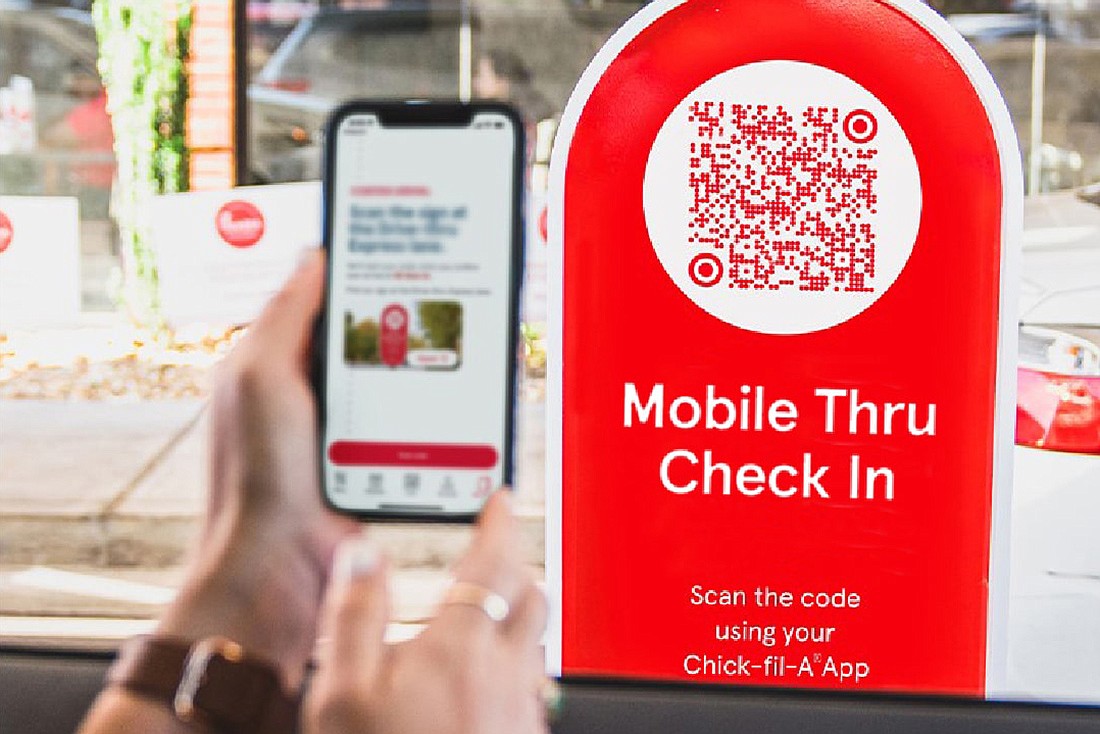 A patron checks into the Chick Fil A app by scanning a QR code at the mobile-only drive-thru lane.