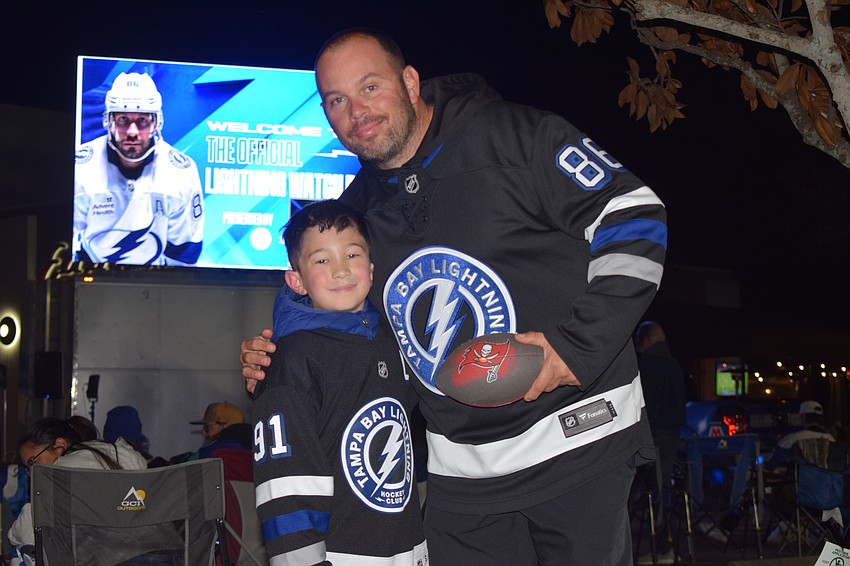 Evan and Chad Hawkins, decked out in their Tampa Bay jerseys, passed the time waiting for the Lightning vs. Devils game to start by playing a game of catch.