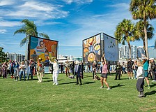 Attendees celebrate the opening of "Embracing Our Differences" at the 2024 exhibition.