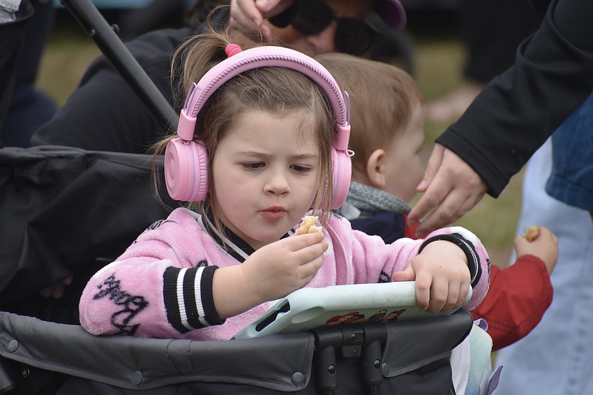 Gracie Bull, 4, whose family is visiting from Ohio and staying with her Siesta Key grandparents Cathy and Jeff Mart, enjoys a festival treat.