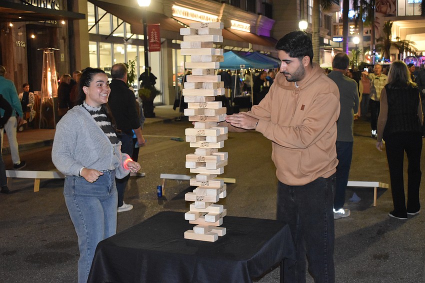 Lisa Vila and Kia Ebr near the end of a game of Jenga.