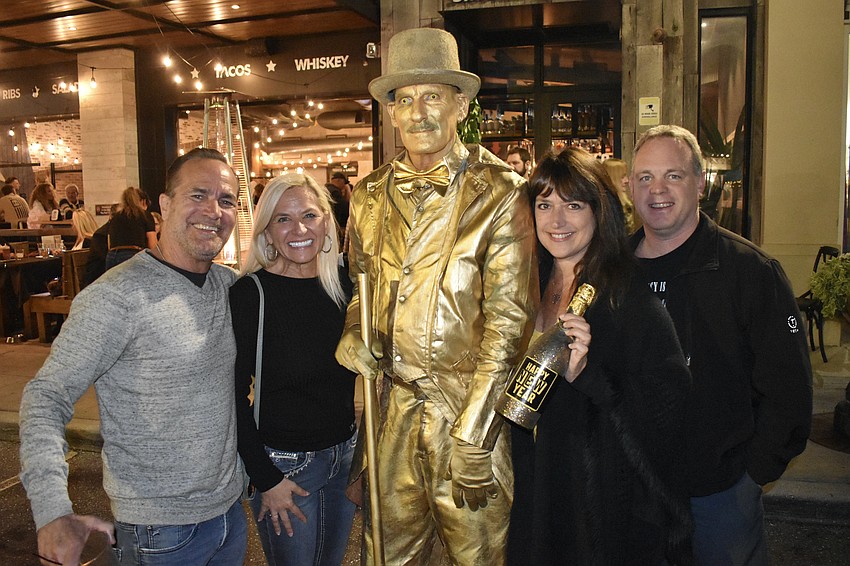 Scott Malouf, Christine Williams, living statue perfomer Joe Abel, Teri Tillaart and Terry Tillaart gather together.