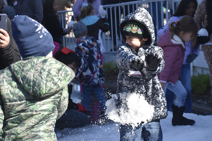 Zachary Darby, 9, tosses a snowball at his brother Joshua Darby, 5.