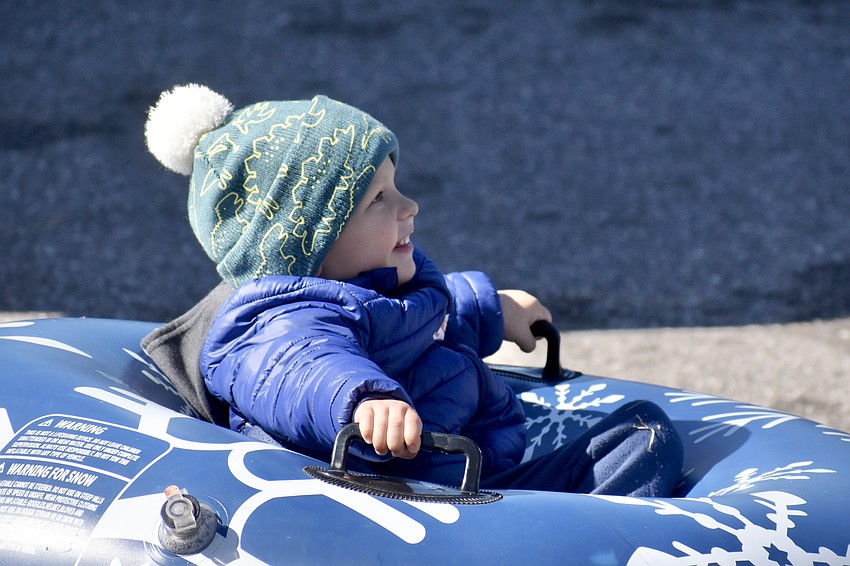 Daniel Nedodaiev, 3, goes down the slide.