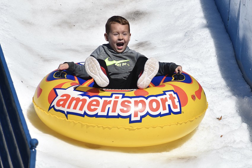 Dale Chelette, 5, enjoys the thrill of a snow slide.
