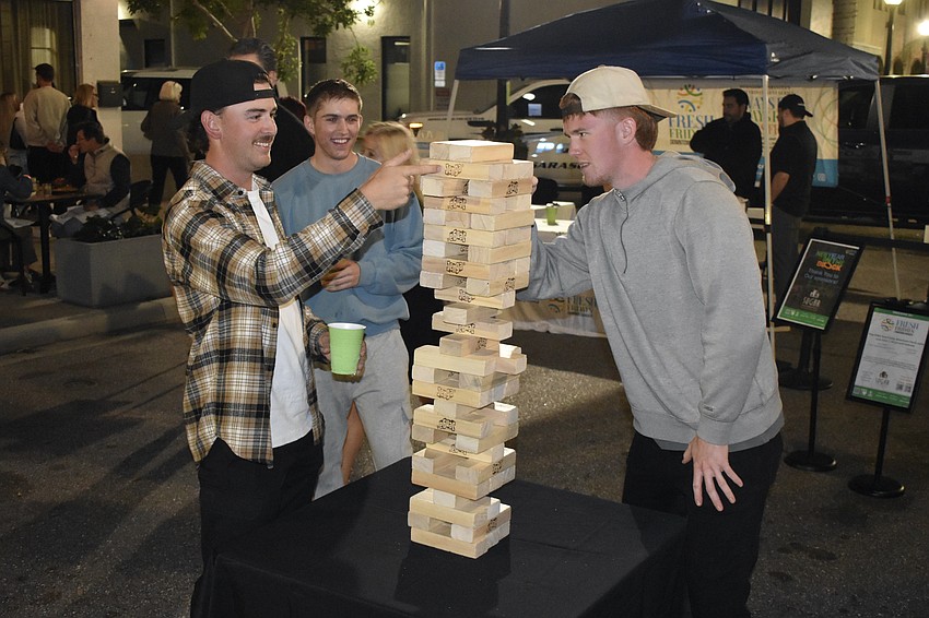 Brandon Rattray, Darin Hudak and Luke Evans play a game of Jenga.