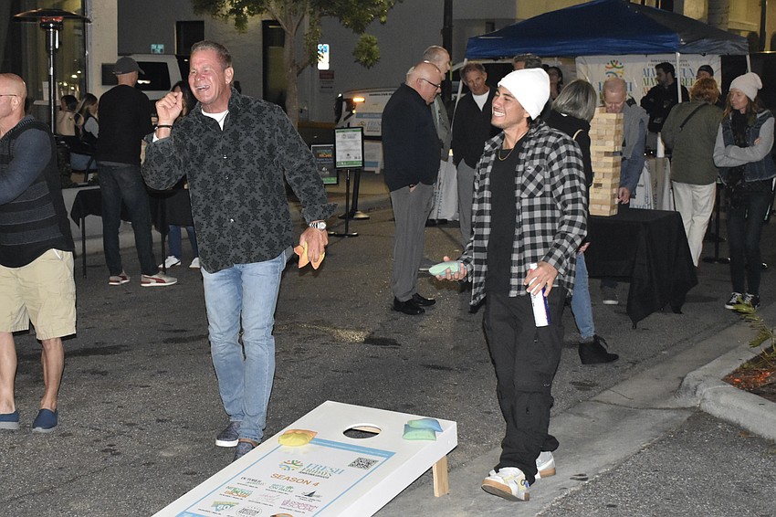 Mark Heffner and Race Arande enjoy a game of cornhole.