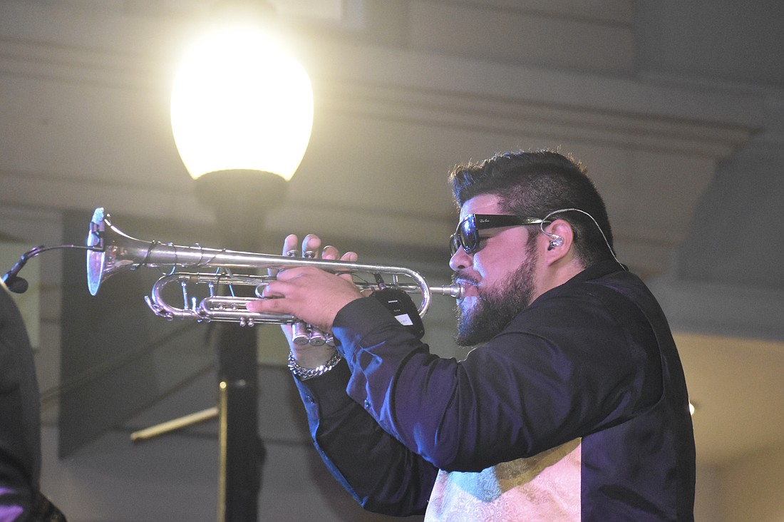 Cesar Lopez of The Danny Bub Combo plays the trumpet.