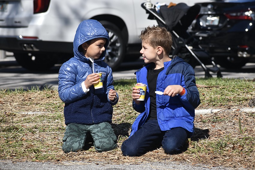 Sebastian Meehan, 7, and Cason West, 7, enjoy snow cones.