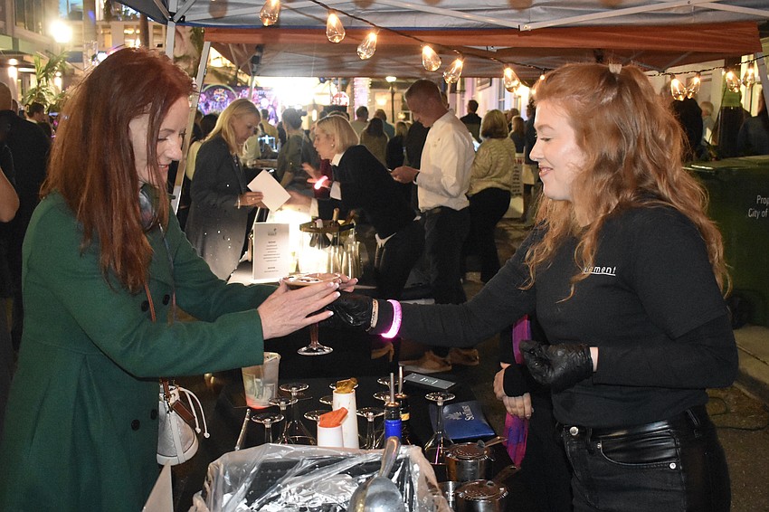 Kathy Burke accepts a drink from Faith Railey.