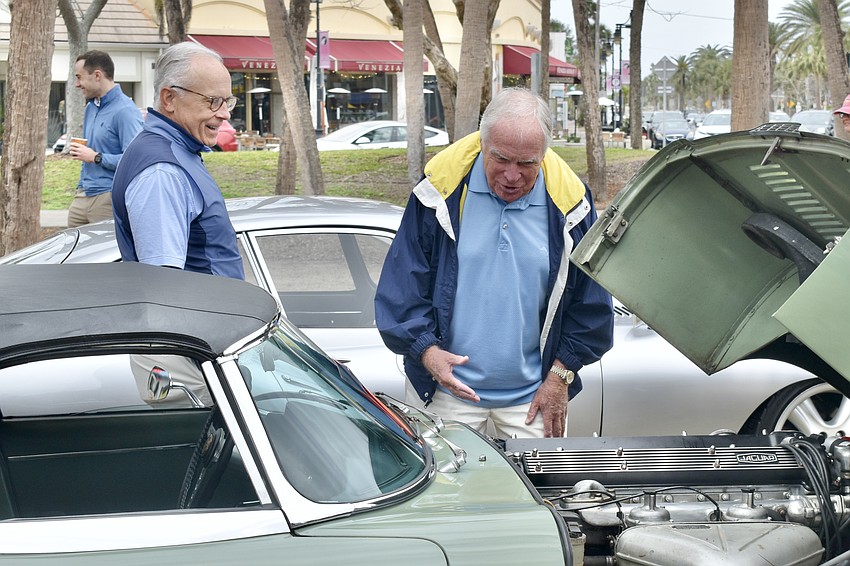 Dan Parke and David Sunter look inside of a car.