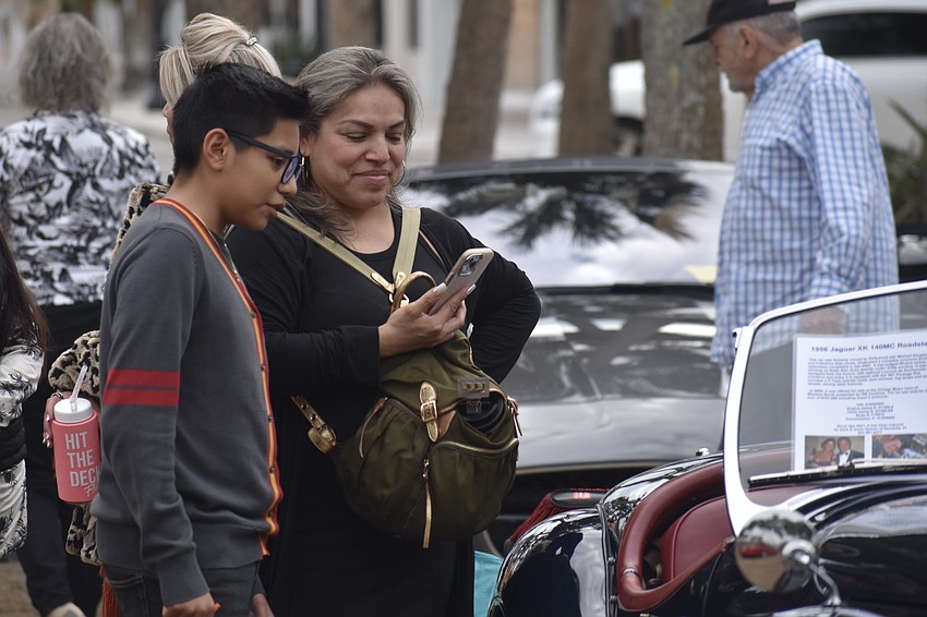 Santiago Fuintos, 13, and Alma Fuintos explore the cars.