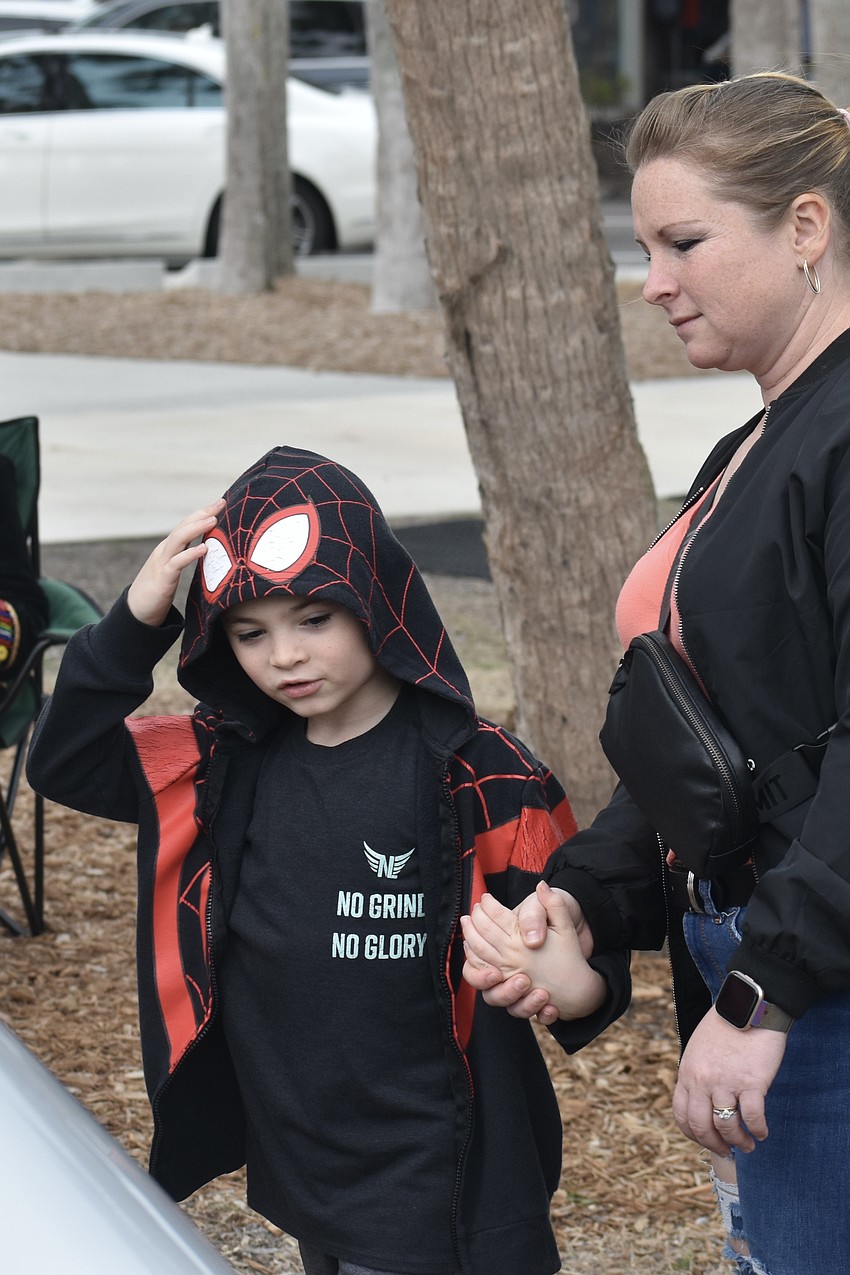 Kristy Breningstall and Jonathan Breningstall, 7, take a look beneath a car hood.