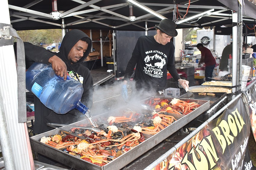 Steven Gillison and Carlos Dravo tend to the Cajun broil.