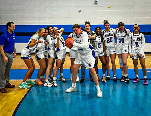 Haley Olson with her teammates after scoring her first basket. Courtesy photo